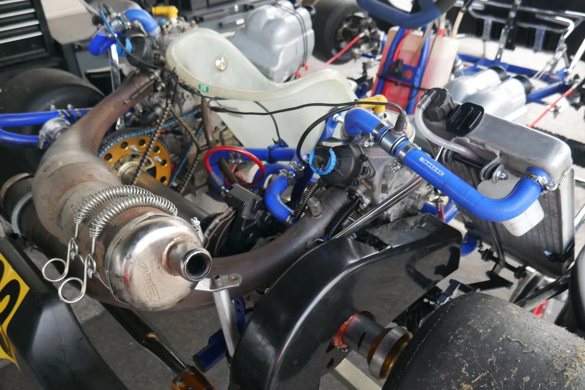 Close-up of the two TM OK engines, exhausts and blue water hoses